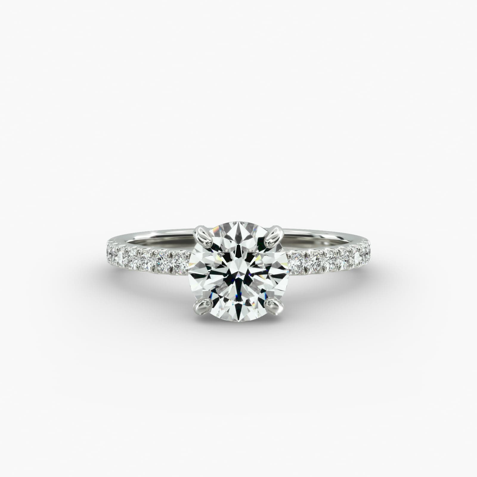 The Petite Pavé Crown hidden halo engagement ring in platinum with a round diamond.