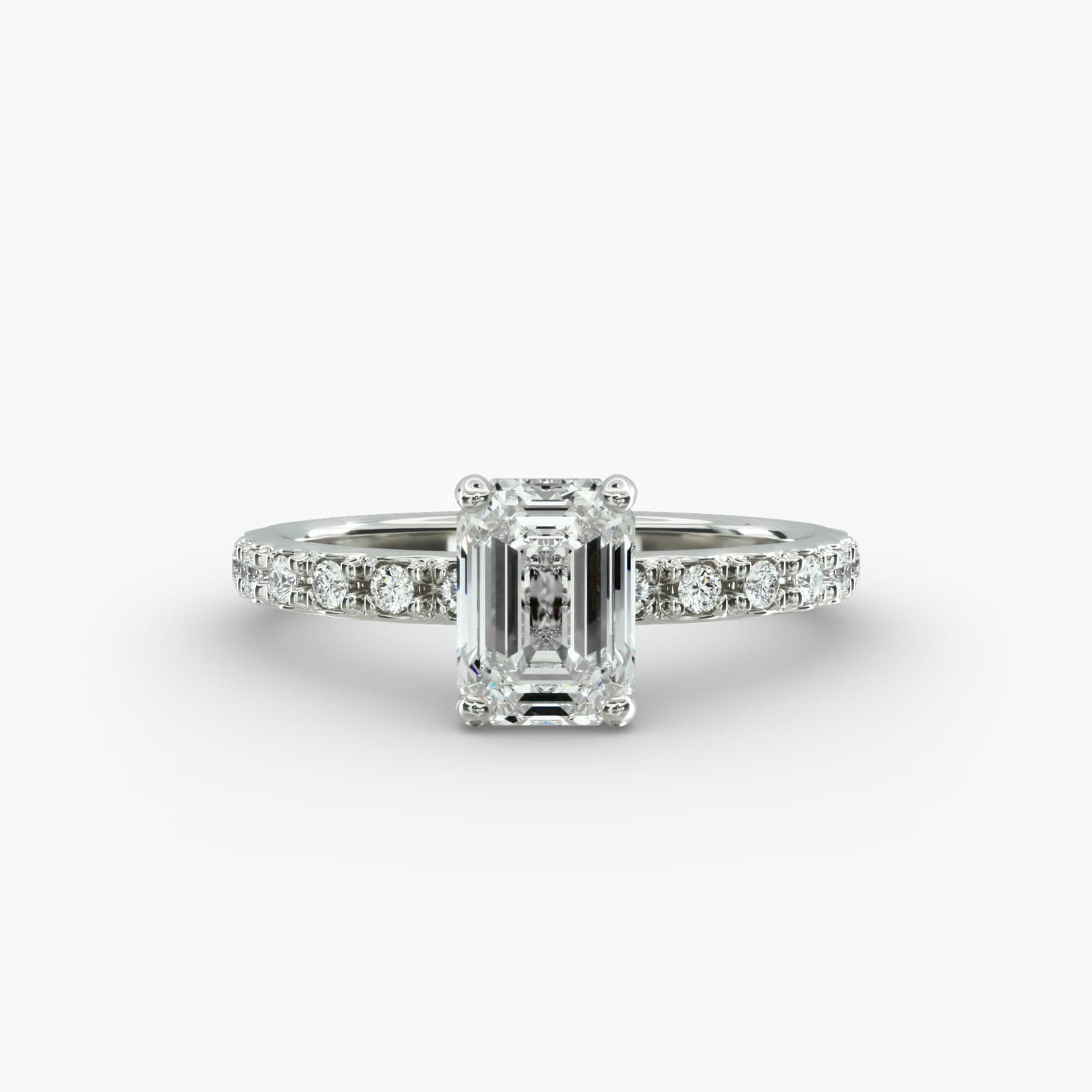A close-up studio shot of a **7 carat diamond ring**, highlighting the stunning clarity of the emerald cut diamond and the delicate detail of the French pavé side stones.