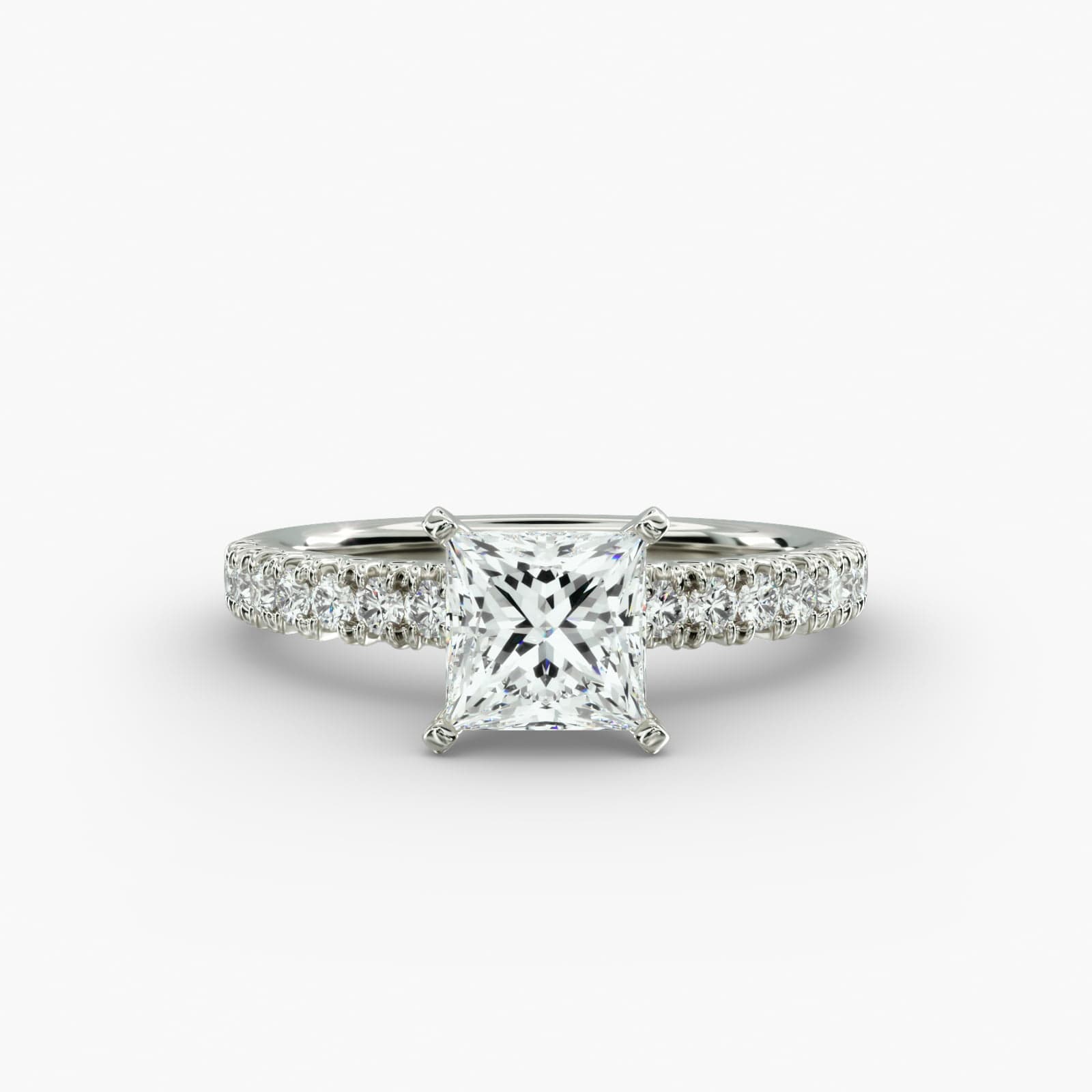 A close-up side view of a 2 carat princess cut diamond engagement ring, highlighting the F-VVS1 clarity of the center stone and the detailed French pavé setting.
